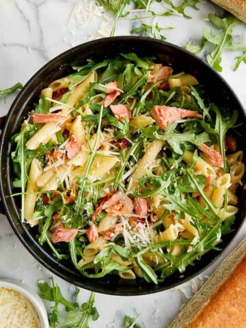 lemon salmon pasta in pot on cutting board.