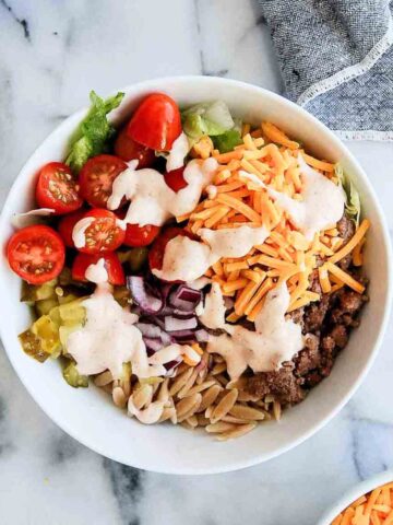 loaded burger bowl with orzo, toppings and special sauce.